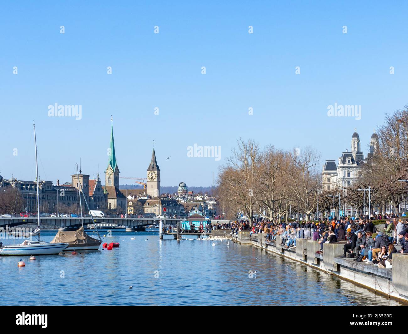 Zurich, Switzerland - March 5th 2022: View along the popular promenade at lake Zurich towards the city centre Stock Photo