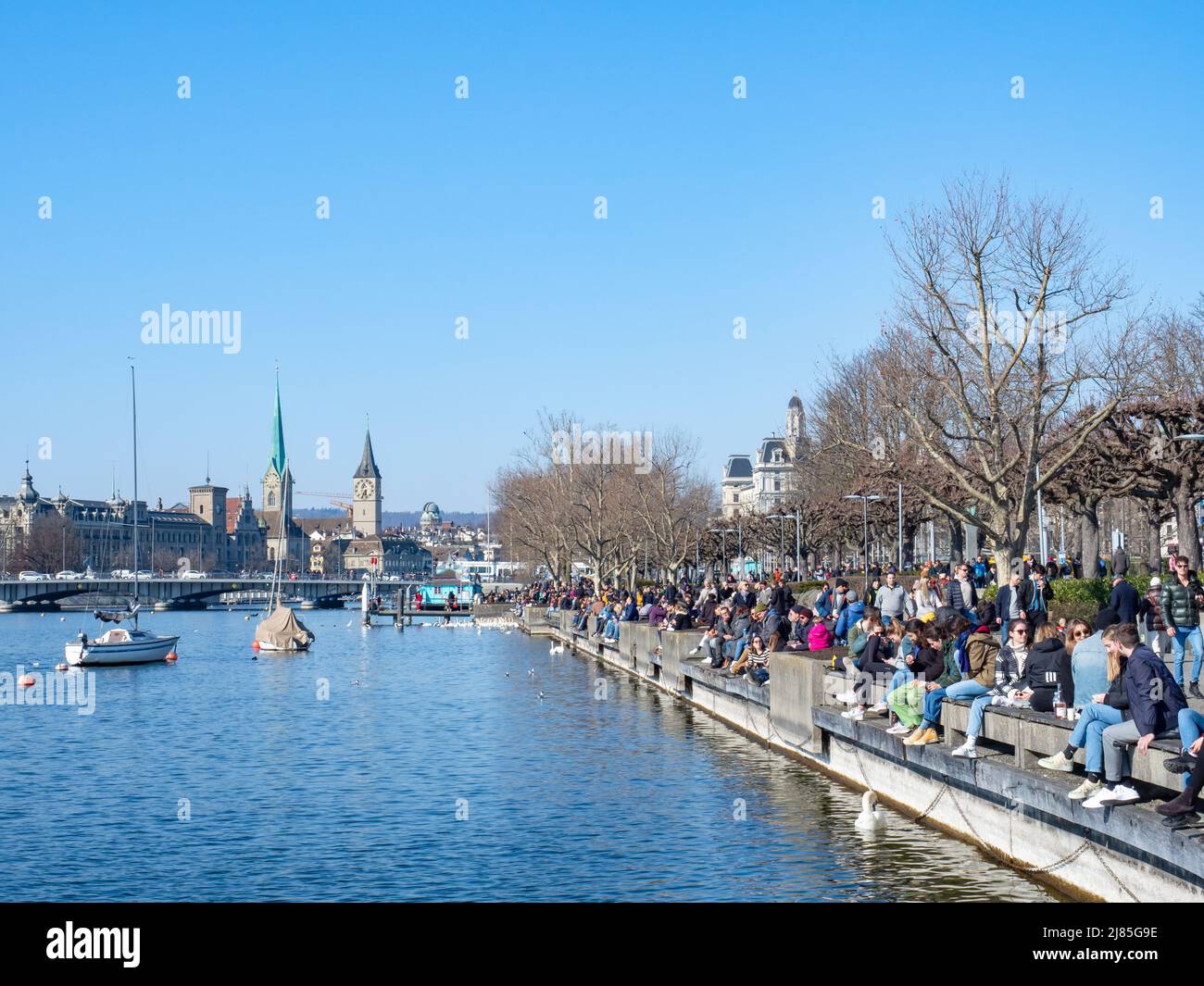 Zurich, Switzerland - March 5th 2022: View along the popular promenade at lake Zurich towards the city centre Stock Photo