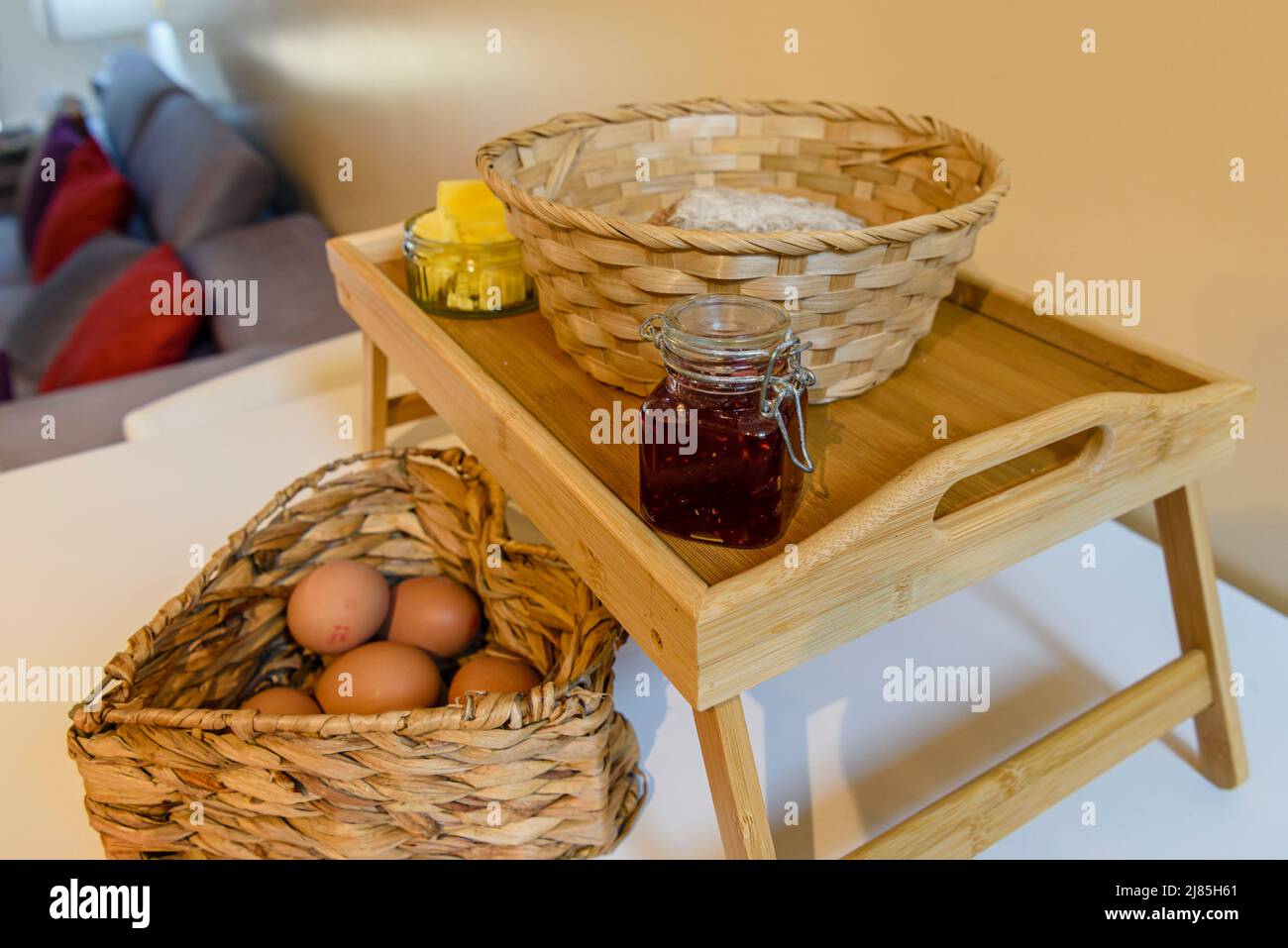 Basket of traditional Irish wheaten bread, eggs, butter and jam at an Air B&B. Stock Photo