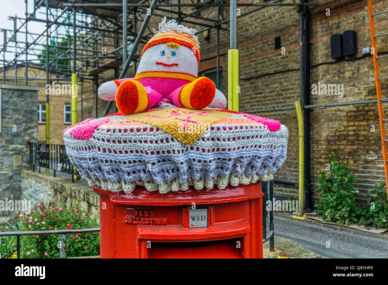 A yarn-bombed pillar box in Beckenham, south London. Stock Photo