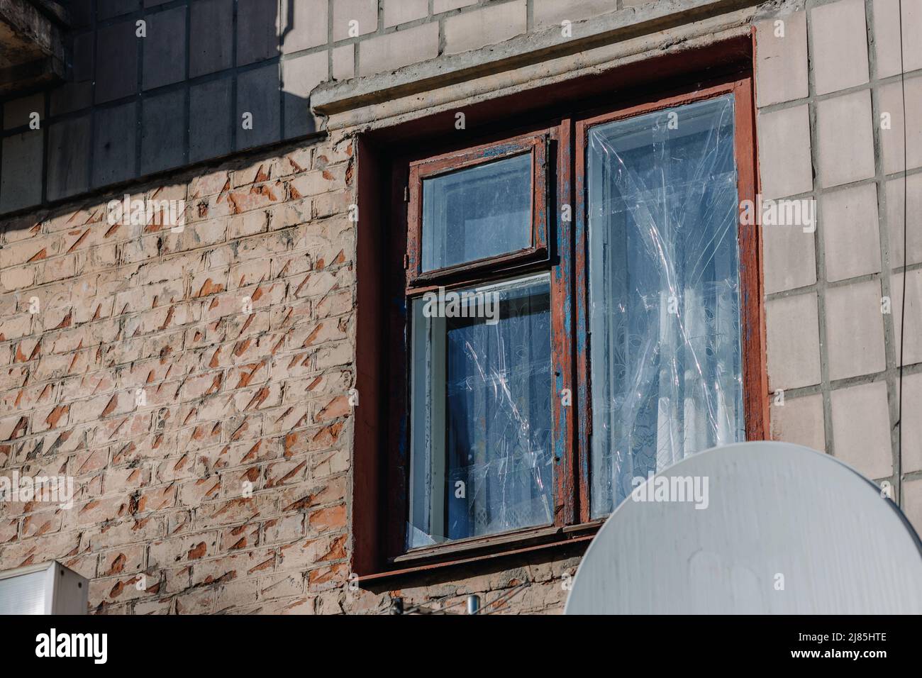 Taped window in an apartment building in the city of Chernihiv near Kyiv in northern Ukraine. Russia's war against Ukraine in 2022. Airstrike. High qu Stock Photo
