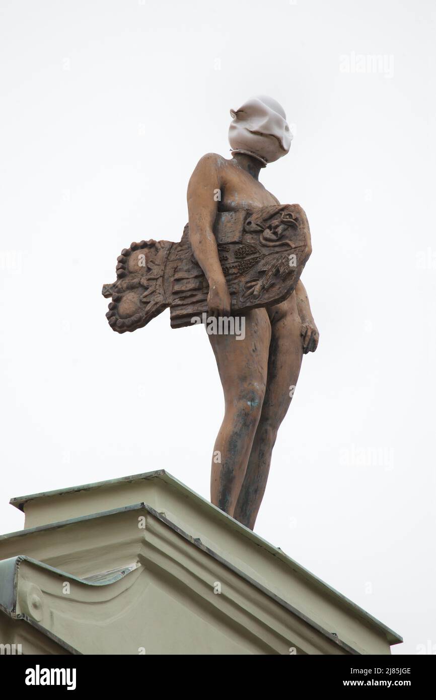 Female statue designed by Czech visual artist David Černý on the main facade of the Deym Palace (Deymovský palác) in Voršilská Street in Nové Město (New Town) in Prague, Czech Republic. Stock Photo