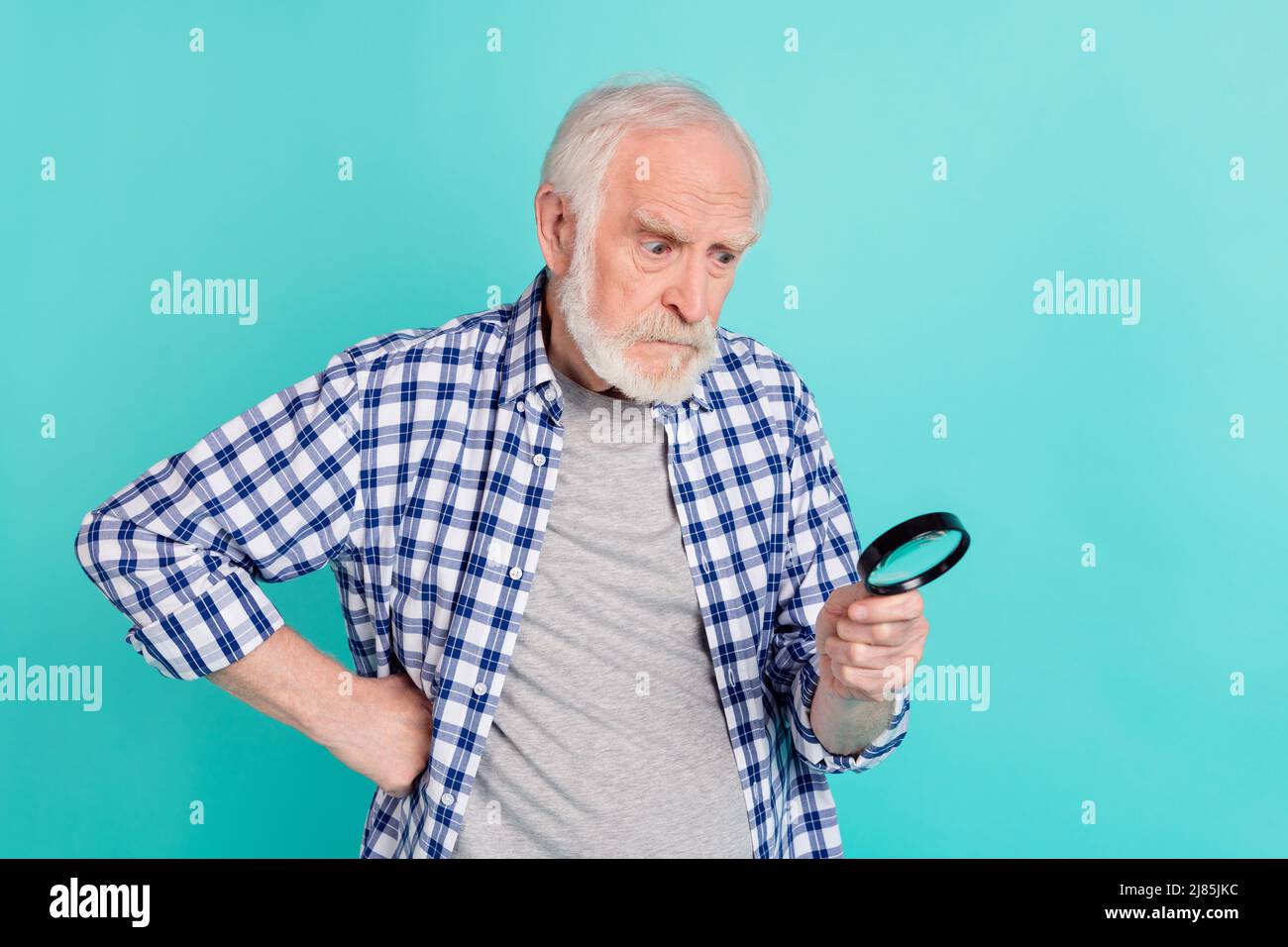 Portrait of aged person put arm waist hold watch magnifier isolated on