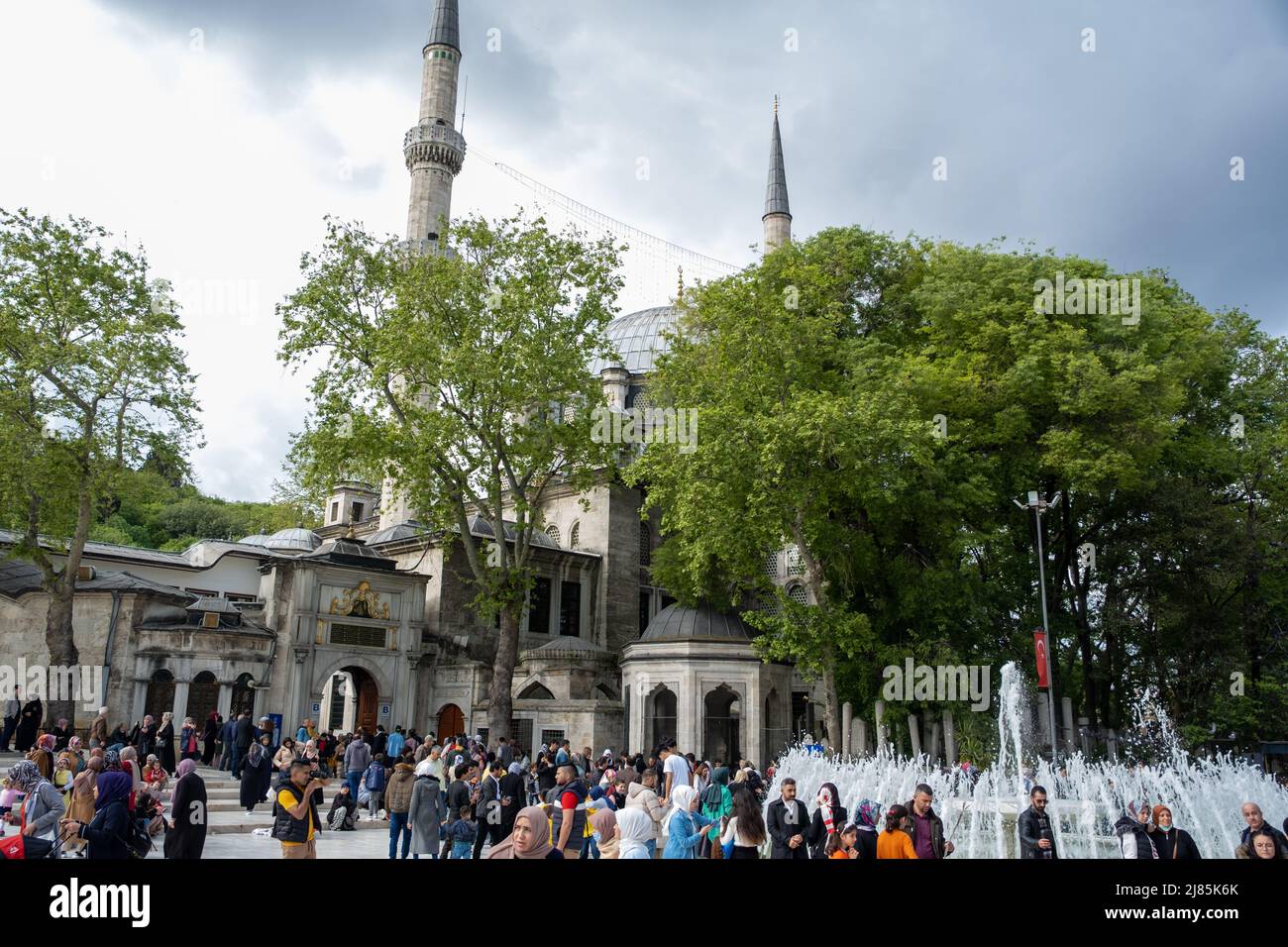 A lot of people with a mosque in the background, Islamic culture and holy place, editorial Eyup Sultan Cami Stock Photo