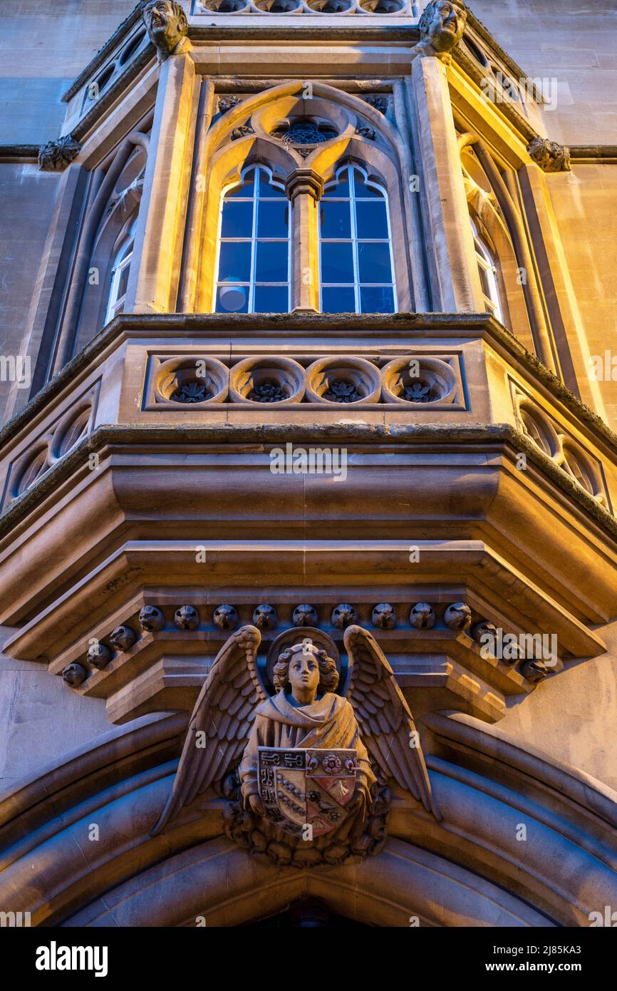 Stone angel and bay window along broad street at dawn. Oxford, Oxfordshire, England Stock Photo