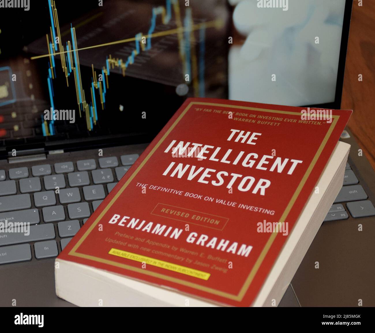 The Intelligent Investor is the best book on stock market investing by  Benjamin graham till date is lying over a laptop Stock Photo - Alamy