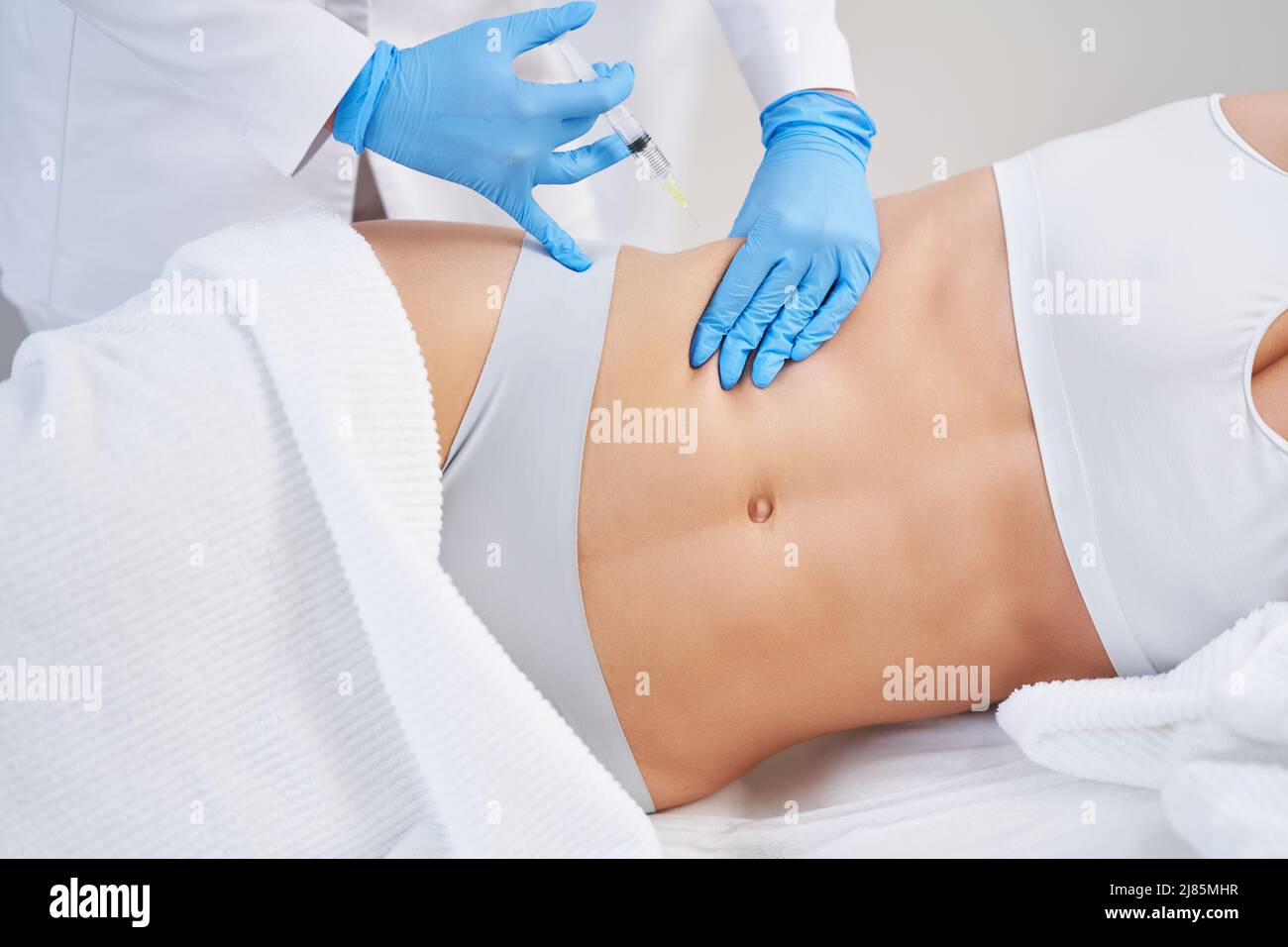 Woman grabbing skin on her flanks with black color crosses marking, Lose  weight and liposuction cellulite removal concept, Isolated on white  backgroun Stock Photo - Alamy