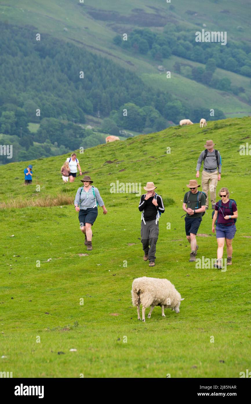 Derbyshire, UK – 5 April 2018: Familes enjoy a walk amid the steep hills of the Peak District National Park near Winnatts Pass Stock Photo