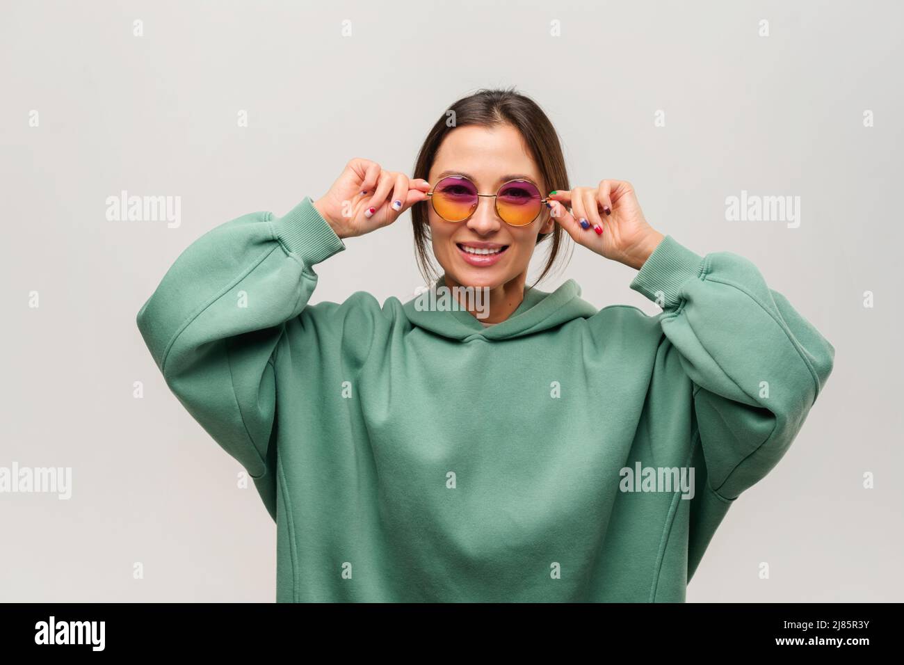 Portrait of smiling beautiful asian girl in sunglasses posing with ...