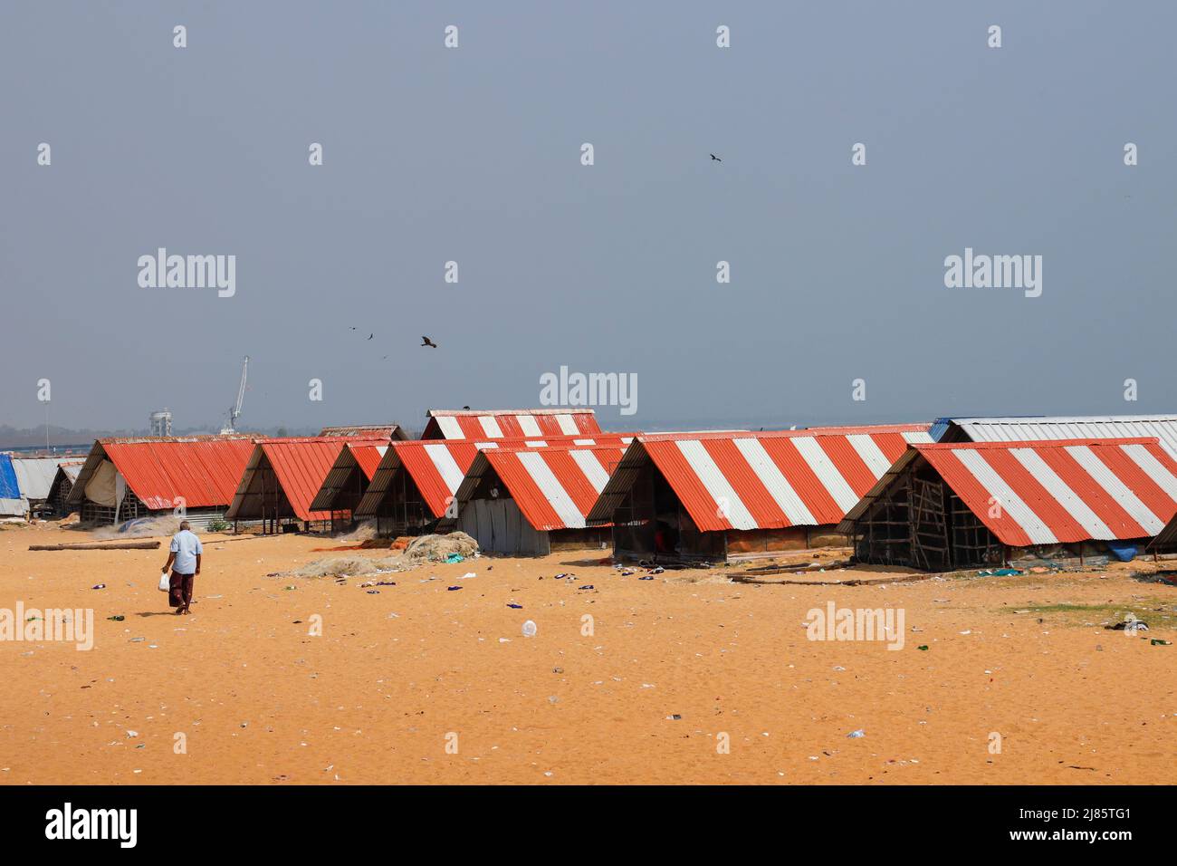 Row of fishermens huts with red and white tin roof, Tangassery, Thangassery, Kerala, India Stock Photo