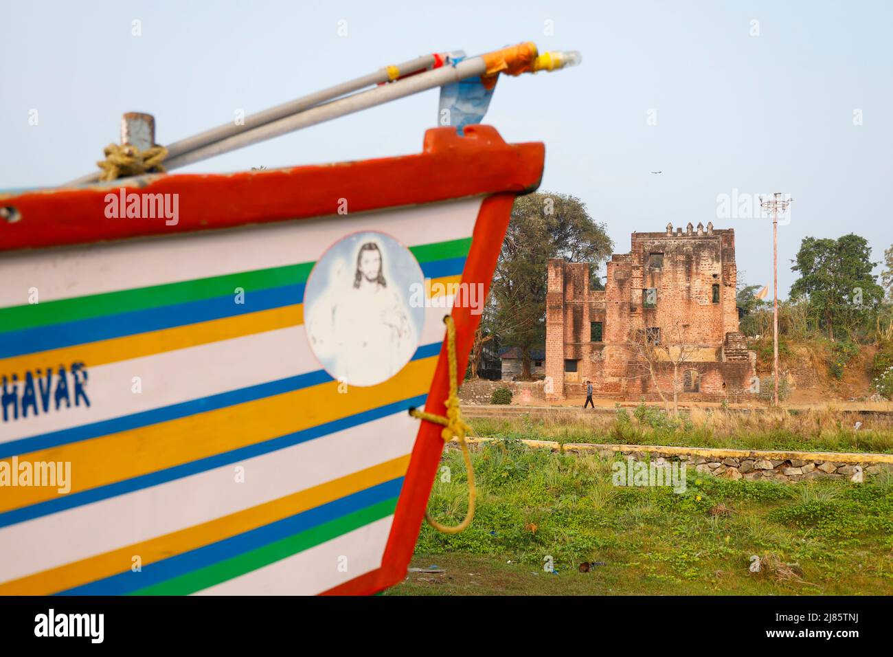 Bow of a fishing boat with the ruins of St.Thomas Fort in the background,Tangassery, Thangassery, Kerala, India. Stock Photo