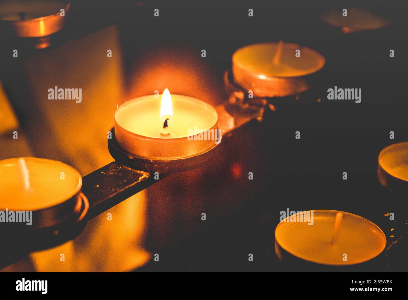 A single illuminated prayer candle lit at Cockington Church, Devon