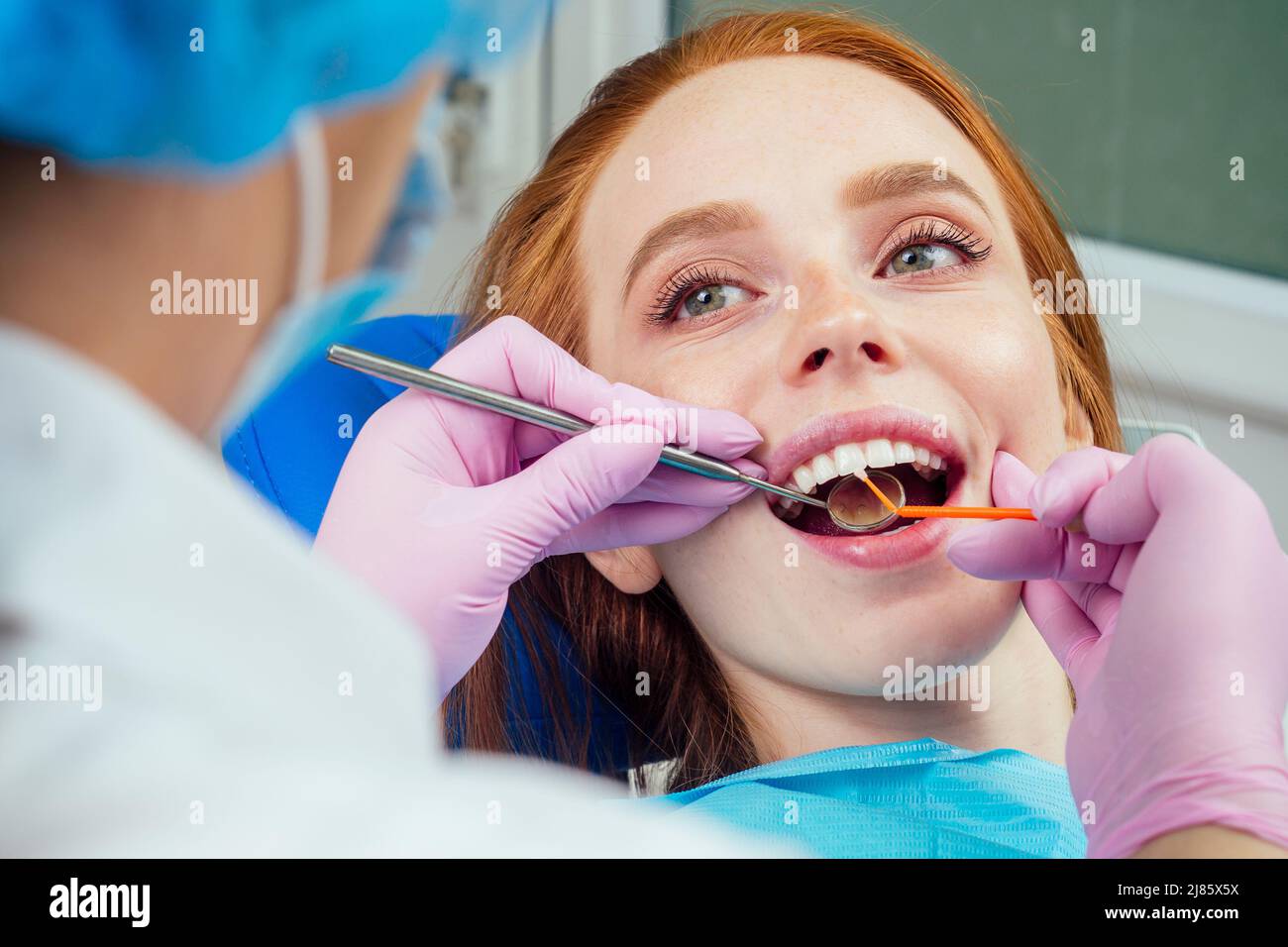 Portrait of an attractive smiling redhaired ginger customer girl in a