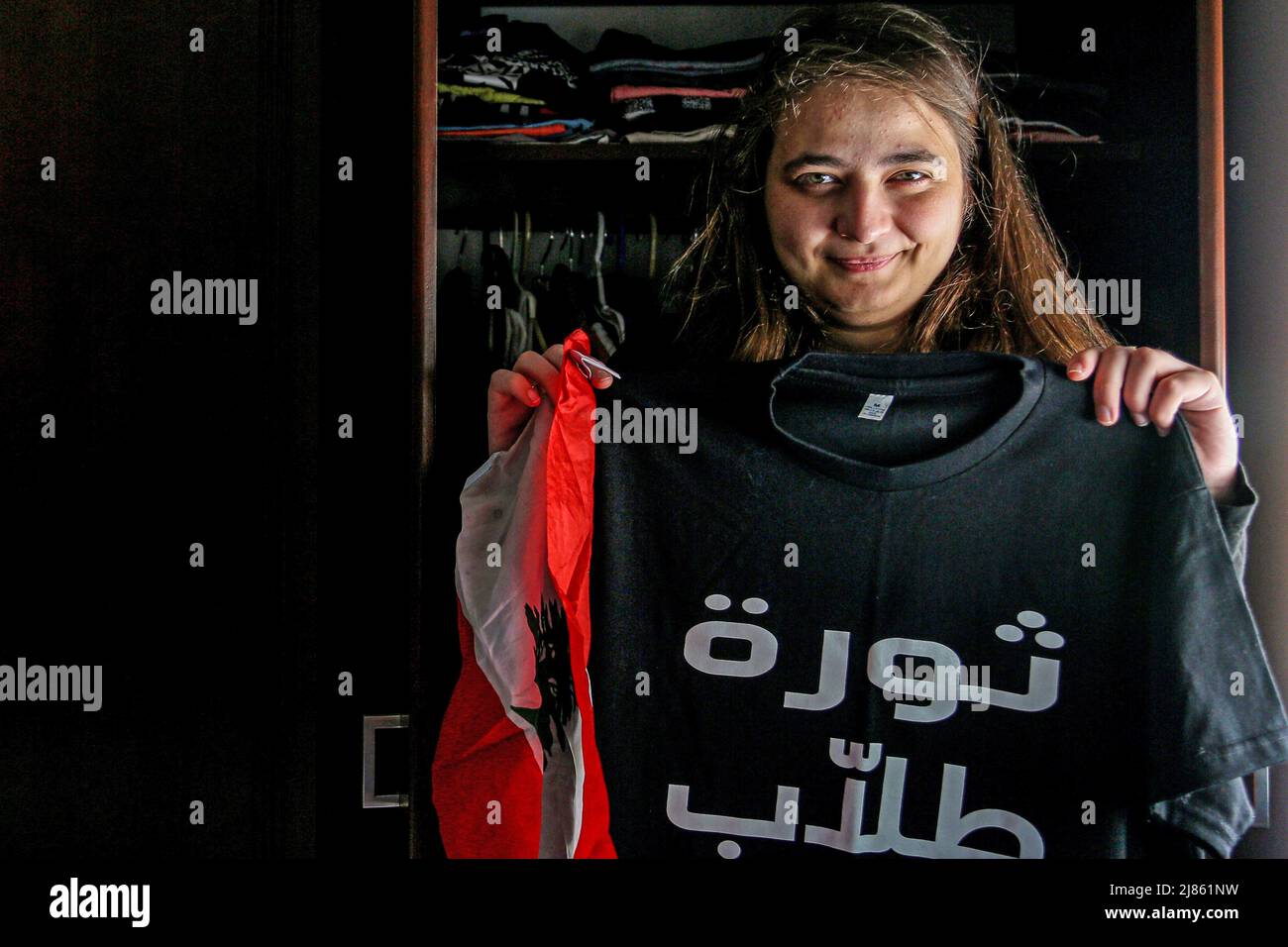 Beirut, Lebanon. 12th May, 2022. Verena al-Amil, 26, Lebanon's youngest parliamentary candidate, poses for a photo wearing a T-shirt with the words 'student revolution' and a Lebanese flag ahead of parliamentary elections set for May 15. (to dpa 'Women against the 'government mafia' - Lebanon votes in crisis parliament') Credit: Marwan Naamani/dpa/Alamy Live News Stock Photo