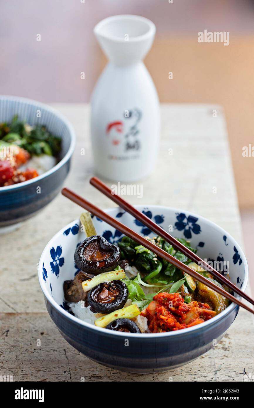 Two coloured bowls of Vegetable Bento with a jar of soy sauce Stock