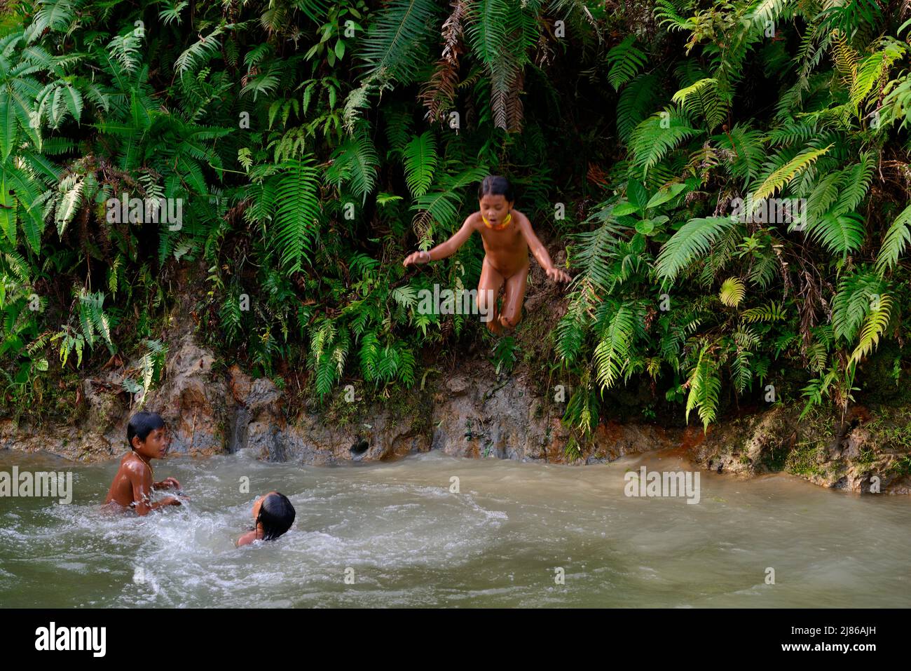 Mentawai childrens playing at the edge of water, Siberut, Mentawai, Indonesia Stock Photo