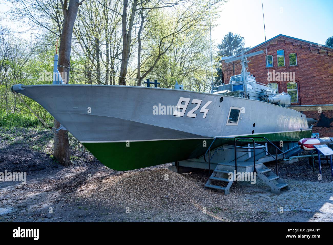 25 April 2022, Mecklenburg-Western Pomerania, Stralsund: On the outdoor grounds of the Dänholm Naval Museum stands torpedo speedboat 'Libelle' - Project 131. The ship was used by the NVA in the Baltic Sea during GDR times. On the island of Dänholm, between the mainland and Rügen, visitors can immerse themselves in naval history on Museum Day in a former barracks. The museum displays original objects from military seafaring such as uniforms and weapons, as well as photos, films and documents. Attractions also include a naval helicopter and a torpedo speedboat. Photo: Stefan Sauer/dpa Stock Photo