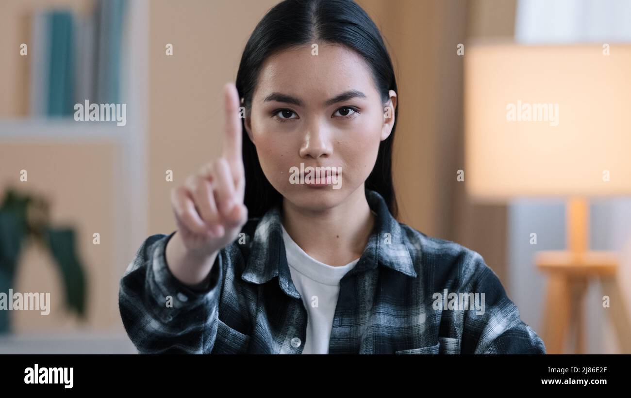 Asian girl portrait woman serious angry aggressive lady waving index finger negative no answer not sign ban forbiddance prohibition disagreement Stock Photo