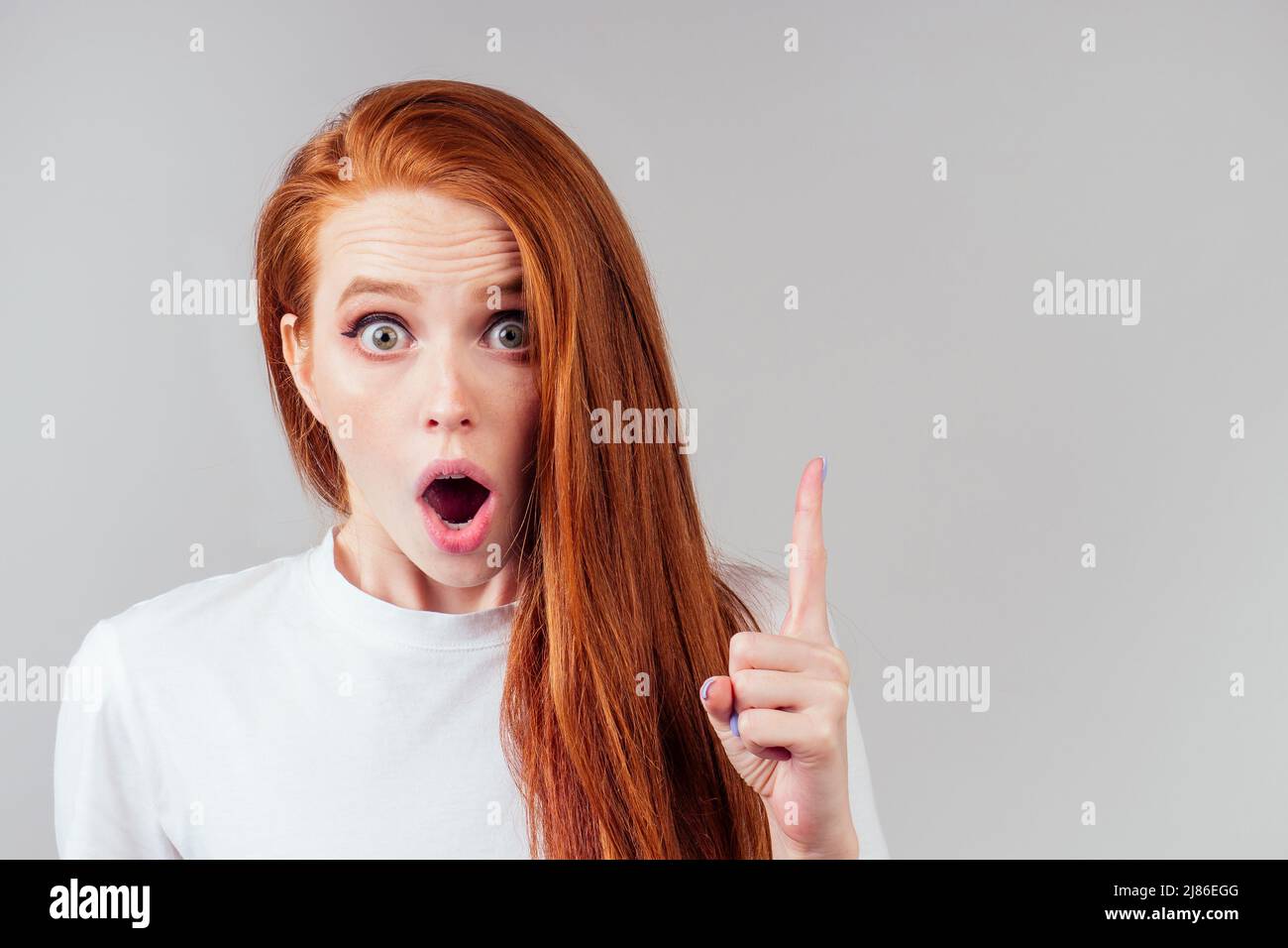 redhair ginger woman finger pointing copy space Stock Photo