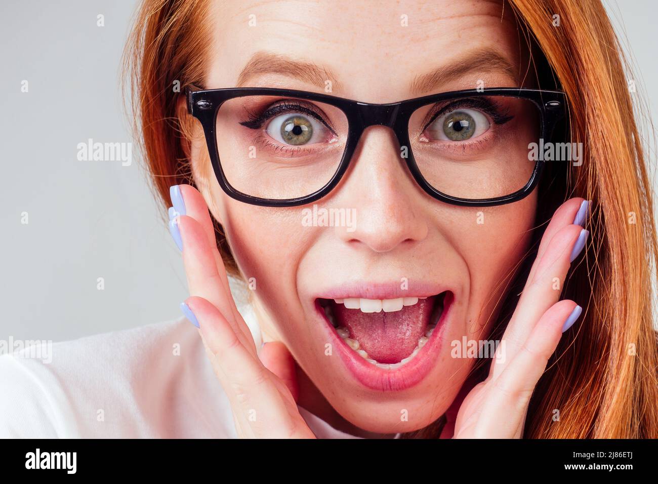 annoying redhaired ginger woman feeling irritation and anger studio background Stock Photo