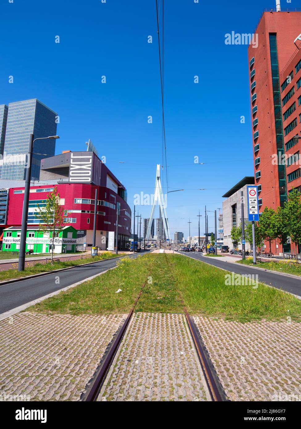 Rotterdam, Netherlands - April 28, 2022: Abandoned tram rails leading to Erasmus bridge in Rotterdam Stock Photo