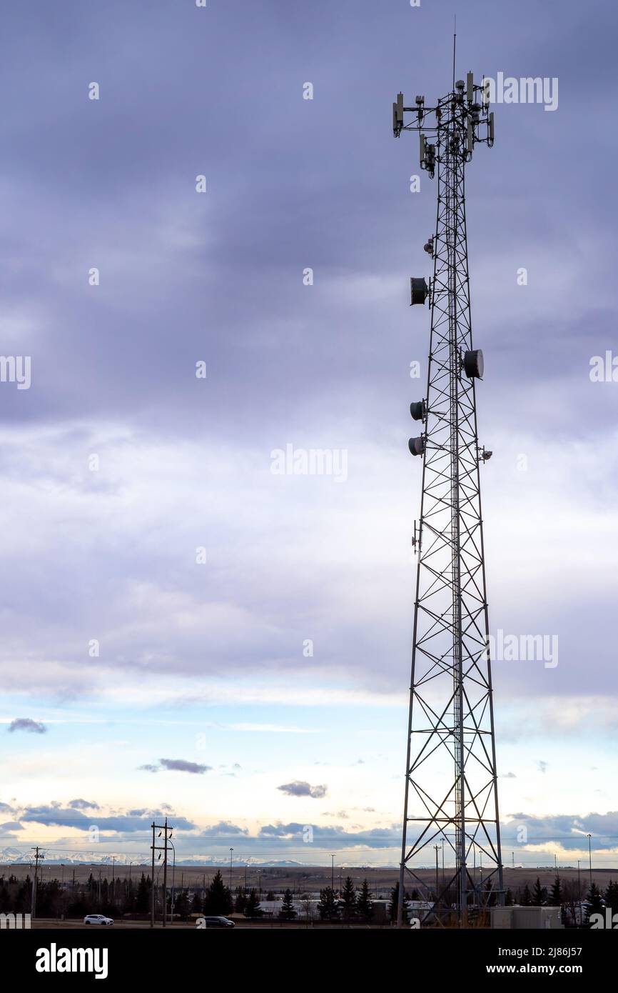 A cell phone tower and communications antenna at a natural park in Airdrie Alberta Canada. Stock Photo
