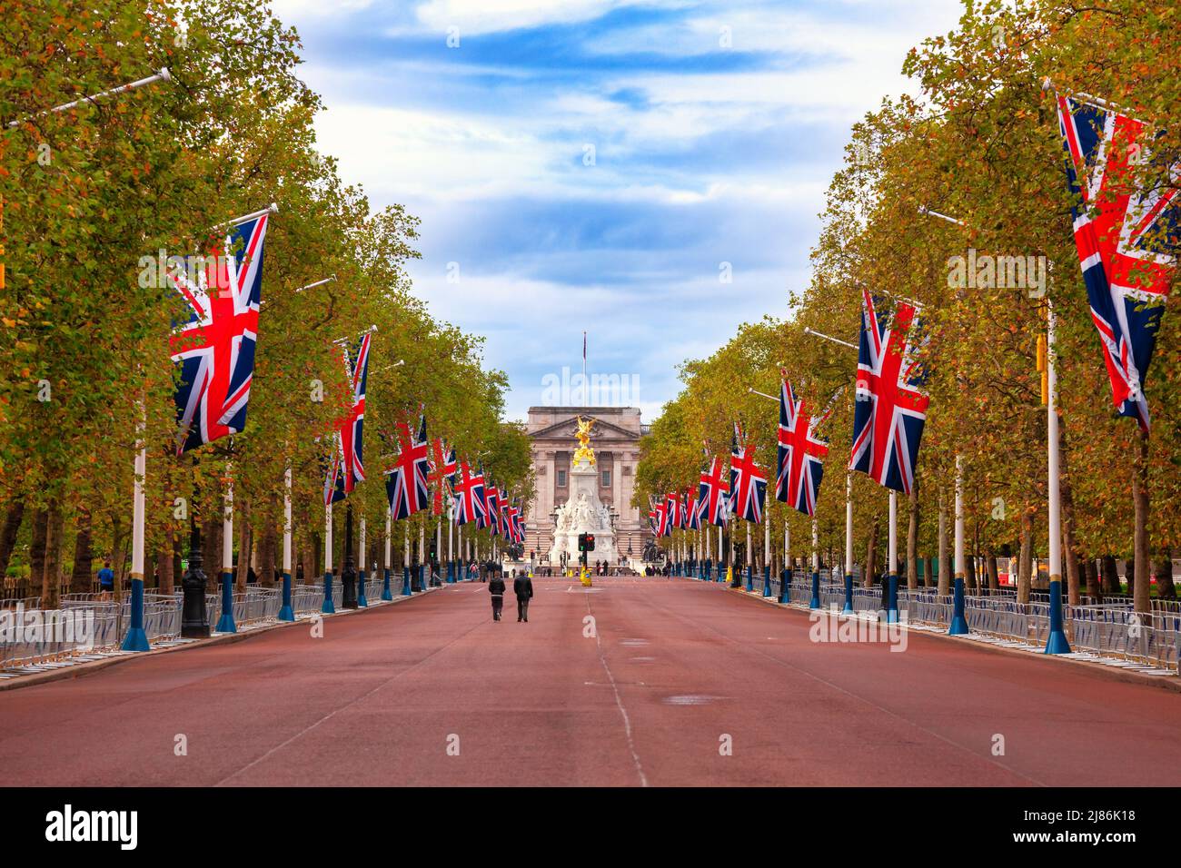 A view along the Mall, the landmark ceremonial approach road to Buckingham Palace decorated with Union Jack flags in City of Westminster, central Lond Stock Photo