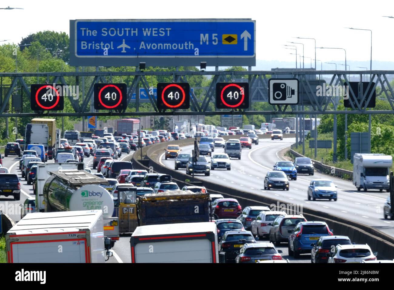 Bristol, UK. 13th May, 2022. Sunny Friday getaway leads to congestion on the M5 motorway. 40 MPH Speed restrictions are in place on the managed section of the M5 motorway at Filton due to the volume of traffic heading south towards Devon and Cornwall. Despite the high cost of fuel people still rely upon their cars. Highways England report speeds of 12 MPH. Credit: JMF News/Alamy Live News Stock Photo