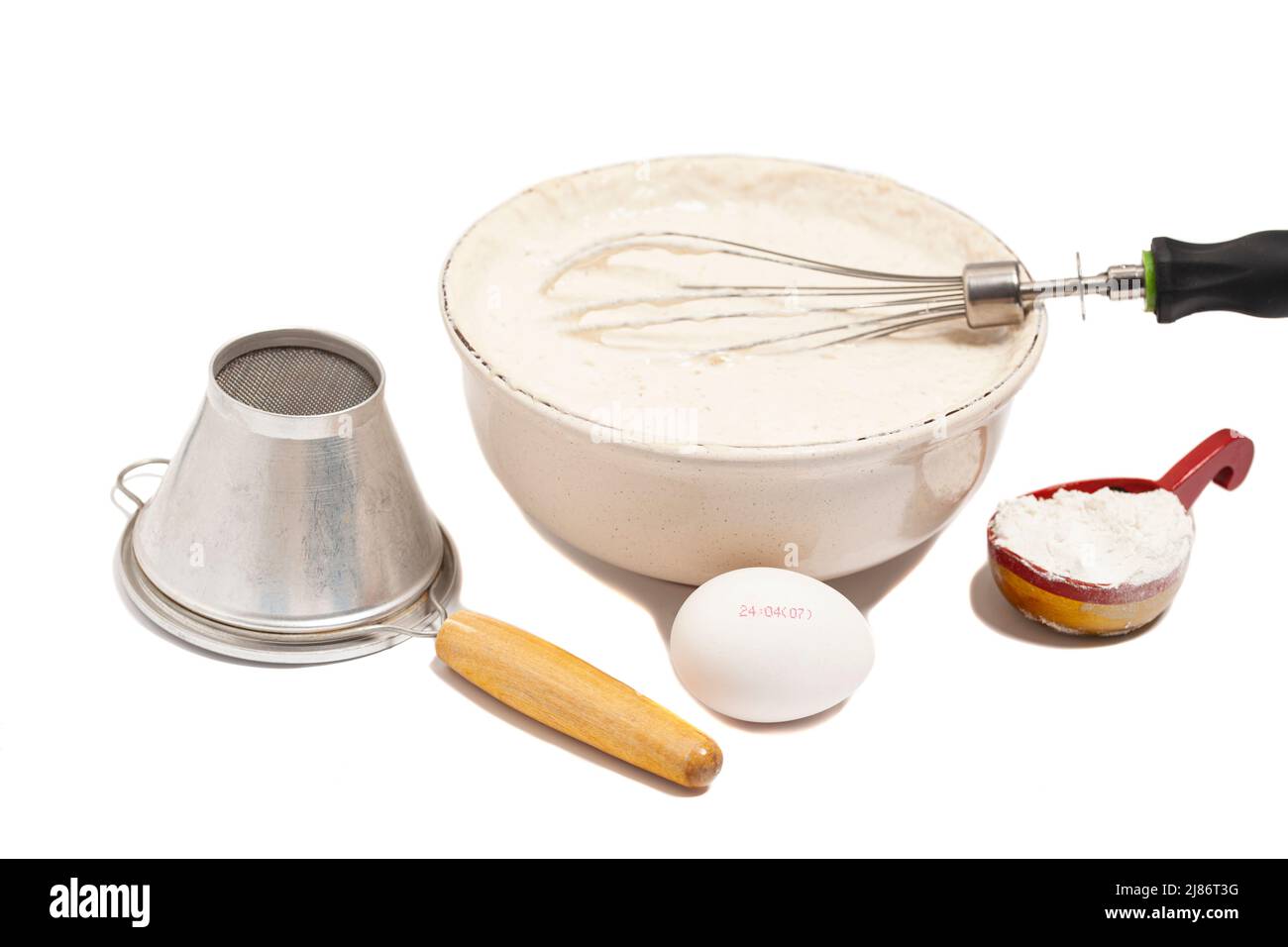 MIxing baking ingredients in a bowl,with egg, dry yeast and sieve for