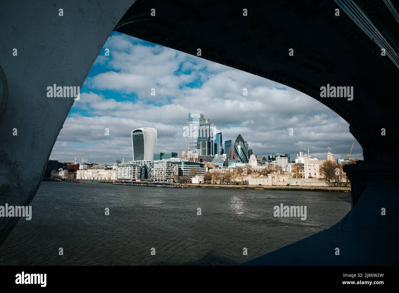 View of the City of London, with the Gherkin, Walkie Talkie and Tower of London from underneath Tower Bridge Stock Photo