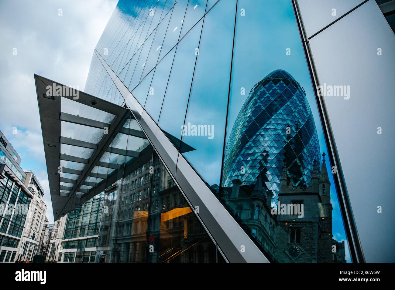 30 St Mary Axe (The Gherkin) reflection on 52-54 Lime Street (The Scalpel), London Stock Photo