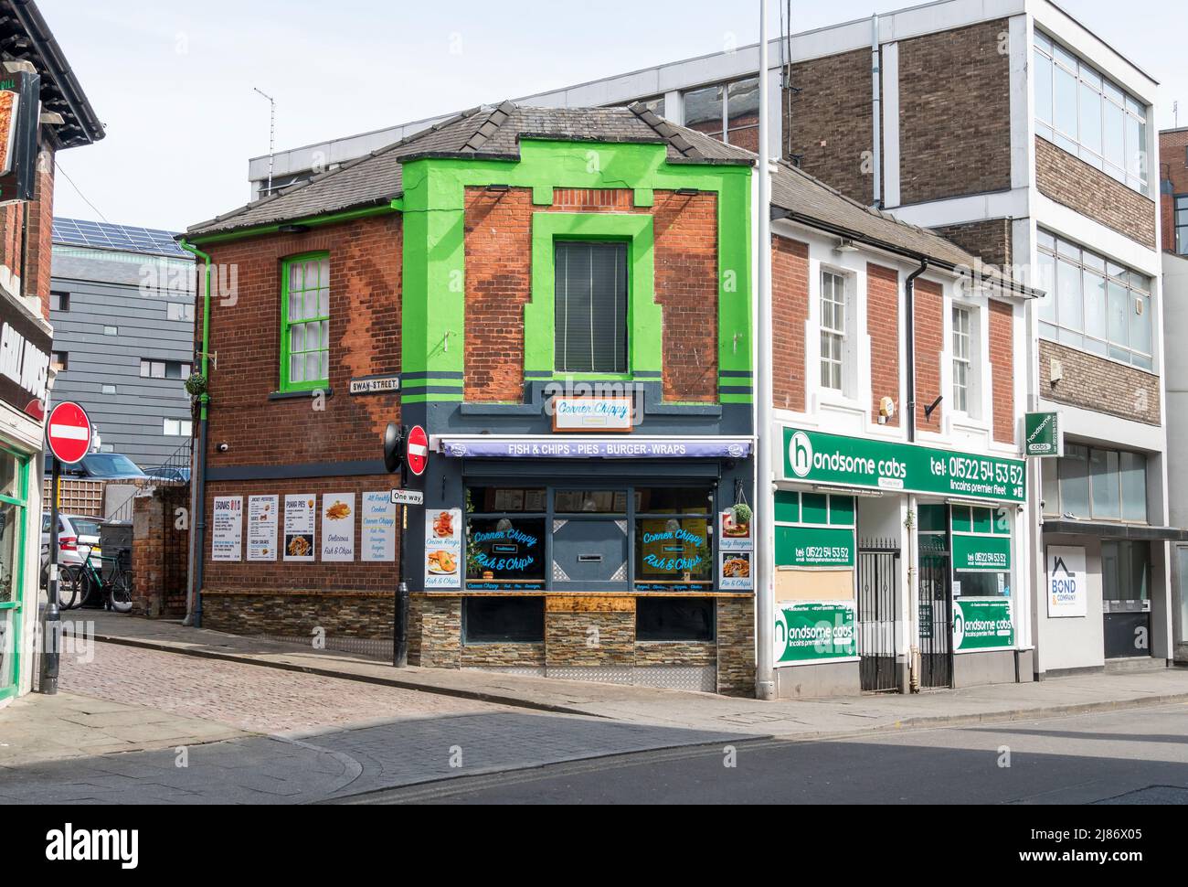1930's style frontage above  corner Chippy junction of Clasketgate and Swan Street Lincoln city 2022 Stock Photo