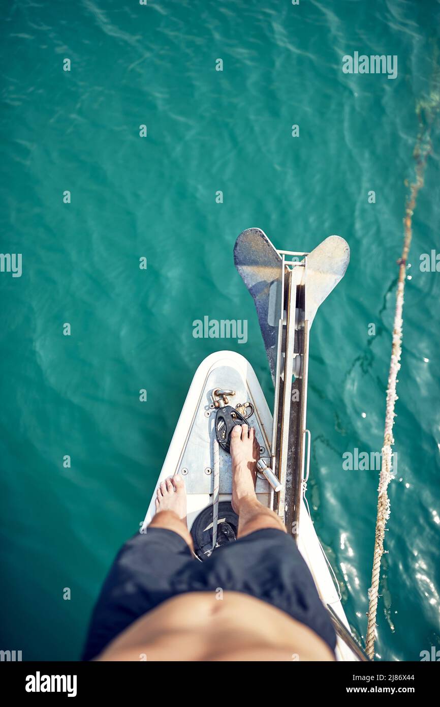 Hansome male sailing alone at the sea; Luxurious lifestyle concept Stock Photo