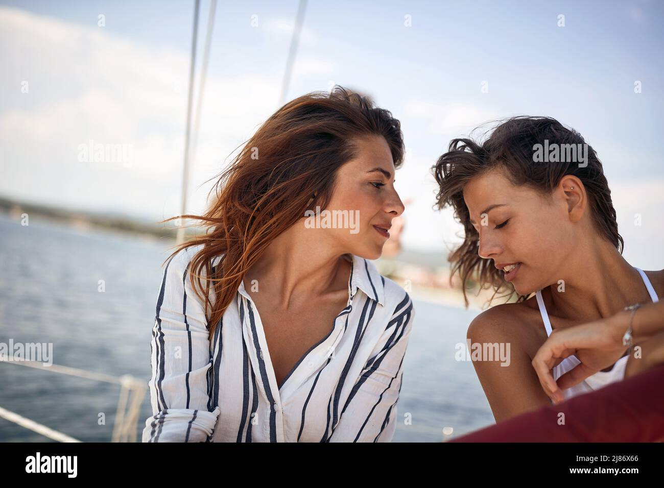 Two young rich girls enjoying together on a yacht Stock Photo