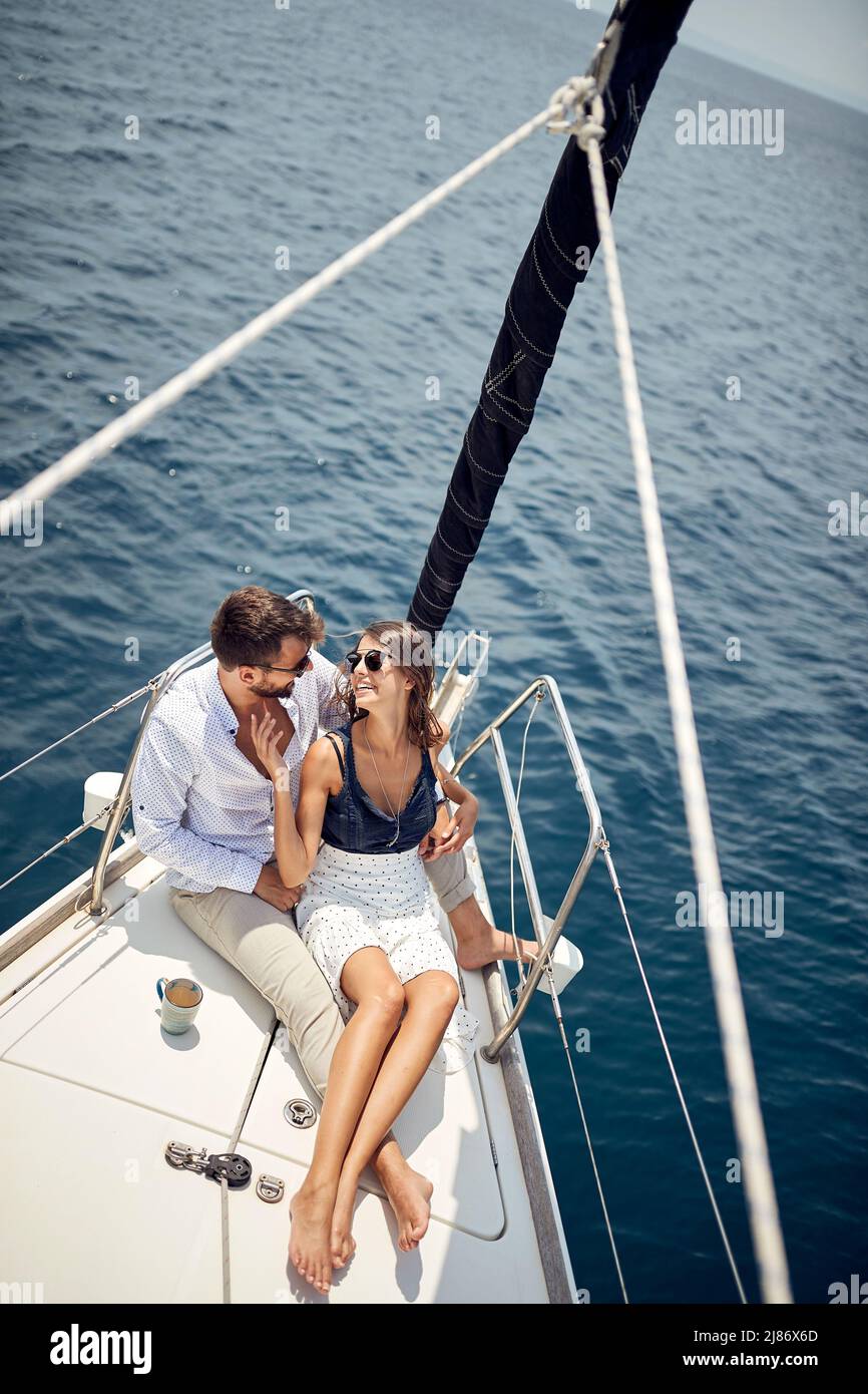 Classy rich couple cruising together on the yacht; Luxurious lifestyle concept Stock Photo