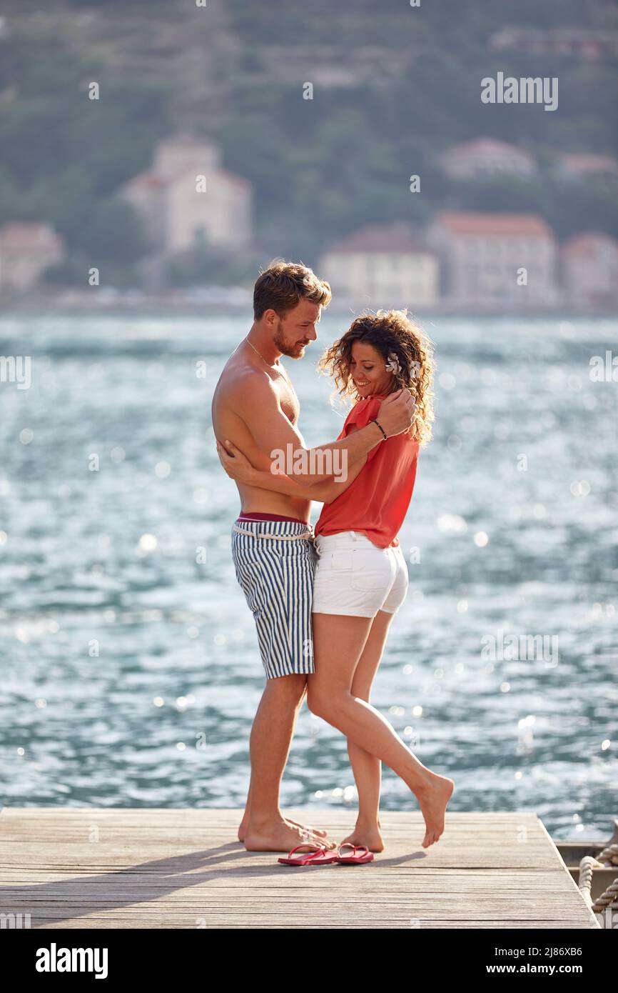 Young smiling man and girl in love flirting by the lake Stock Photo