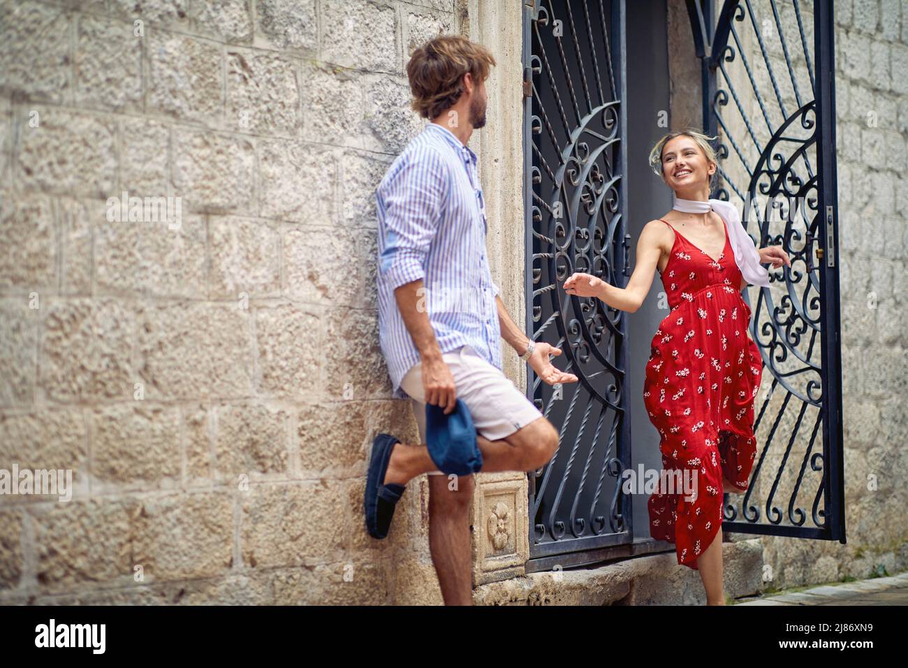 A young couple is enjoying their time in the old city on a beautiful day during a vacation on the seaside. Vacation, seaside, relationship, tourists Stock Photo