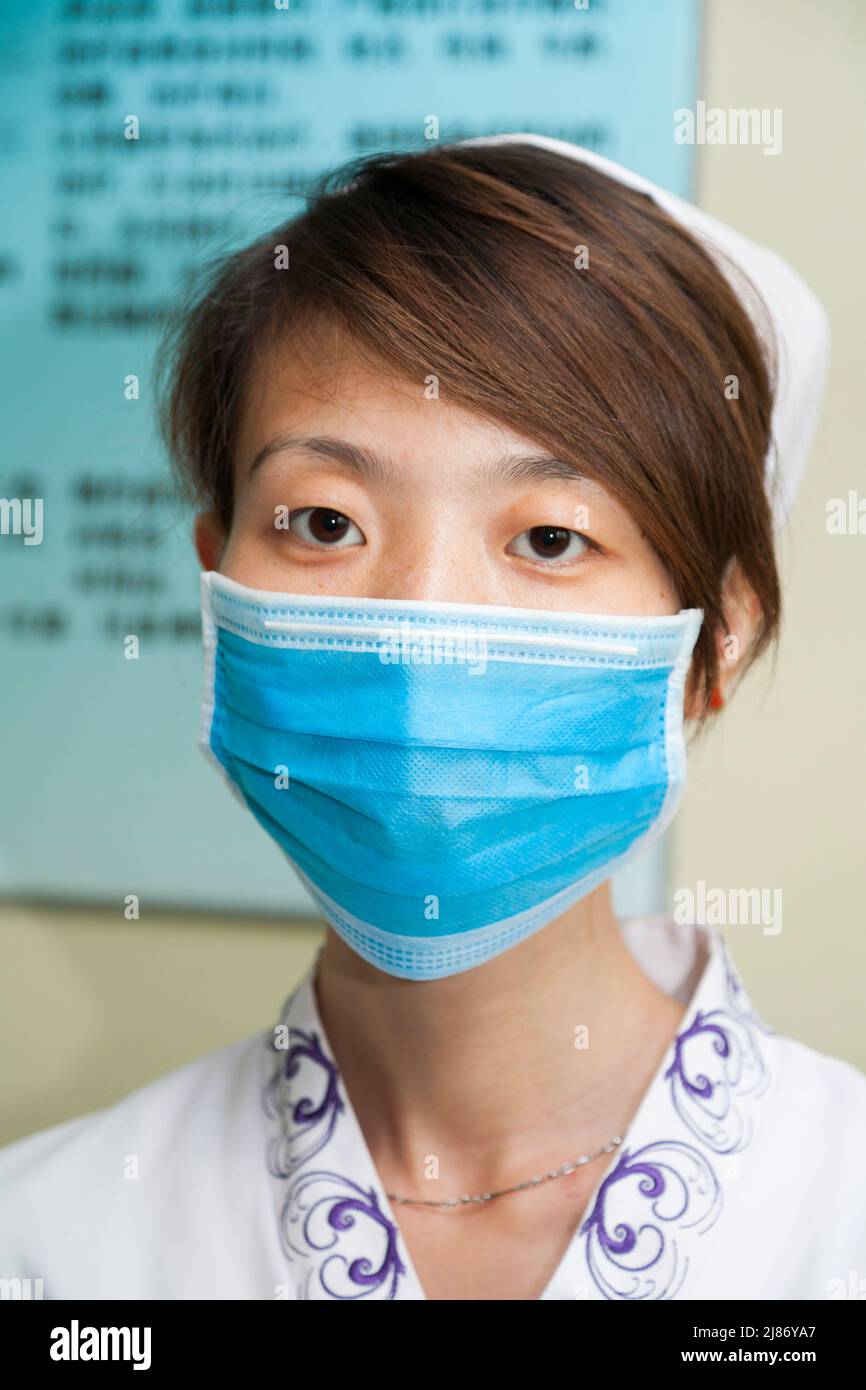 Nurse female medical staff, woman, in uniform and wearing surgical face ...