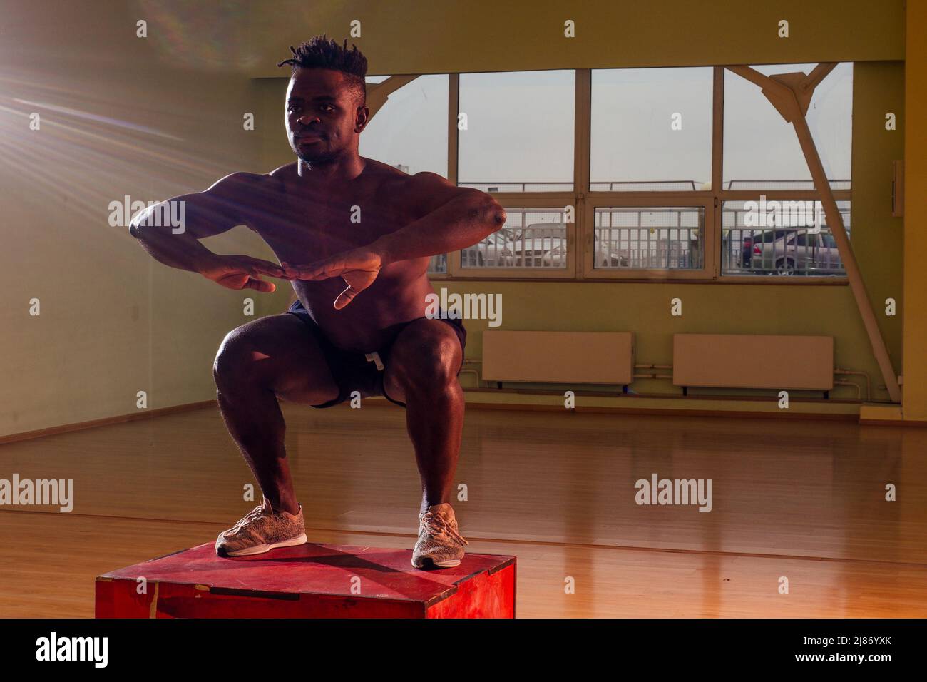 afro man doing exercise with a fit box in a gym Stock Photo Alamy