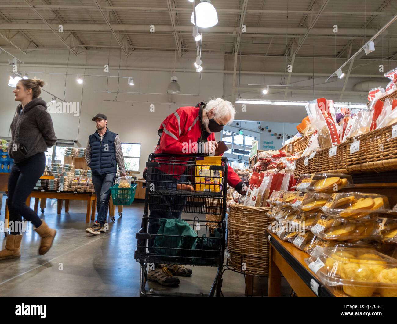 Mill Creek, WA USA - circa May 2022: View of an elderly man shopping in the breads and pastries section of a Town and Country grocery store Stock Photo