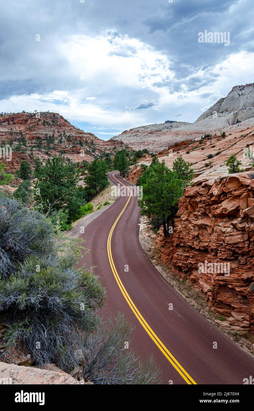 Curvy road through the desert mountains in Zion Canyon in the USA Stock Photo