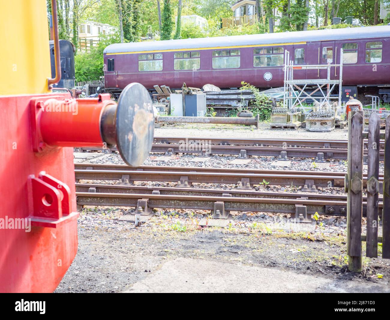 Reepham, Norfolk, UK – May 08 2022. Close and selective focus on the bumpers and hook on the front of a steam train housed in a disused railway yard Stock Photo