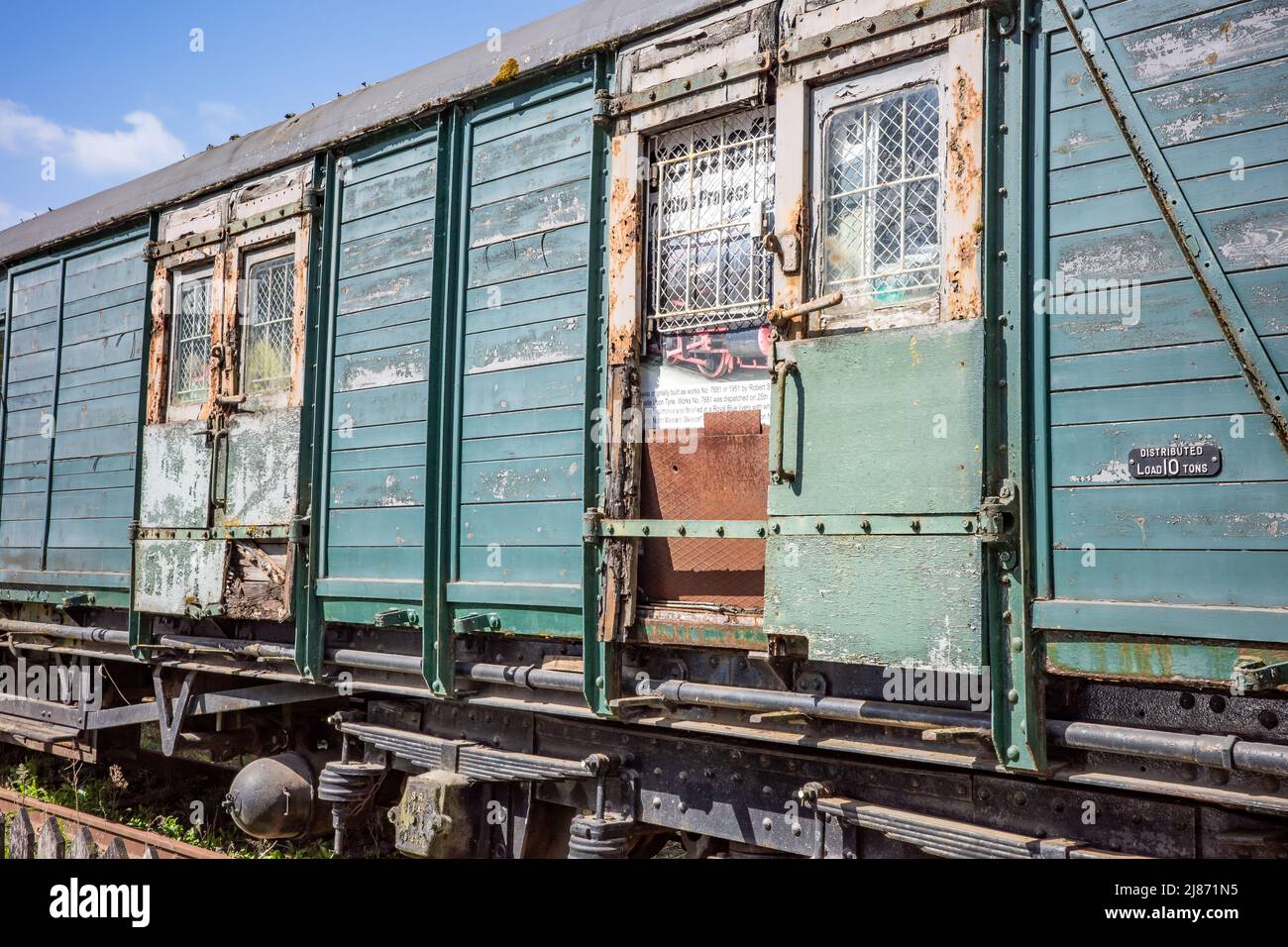 Old, disused and abandoned wooden railway carriage in an old and