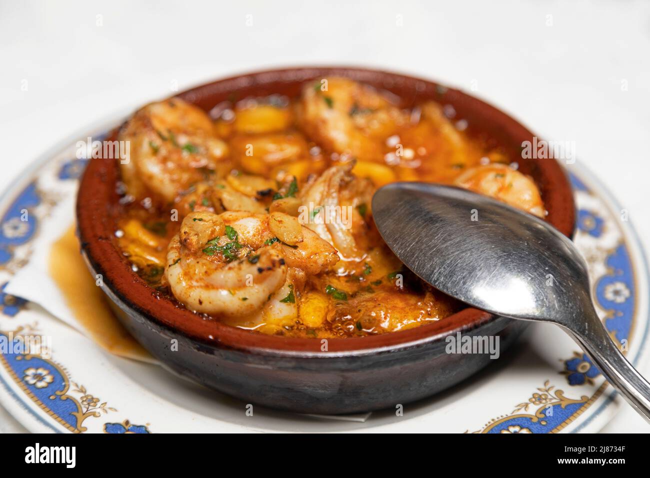 Shrimp cooked in olive oil with garlic (gambas al ajillo) served as an appetiser at a restaurant in Tenerife, Spain. The dish is a popular and traditi Stock Photo