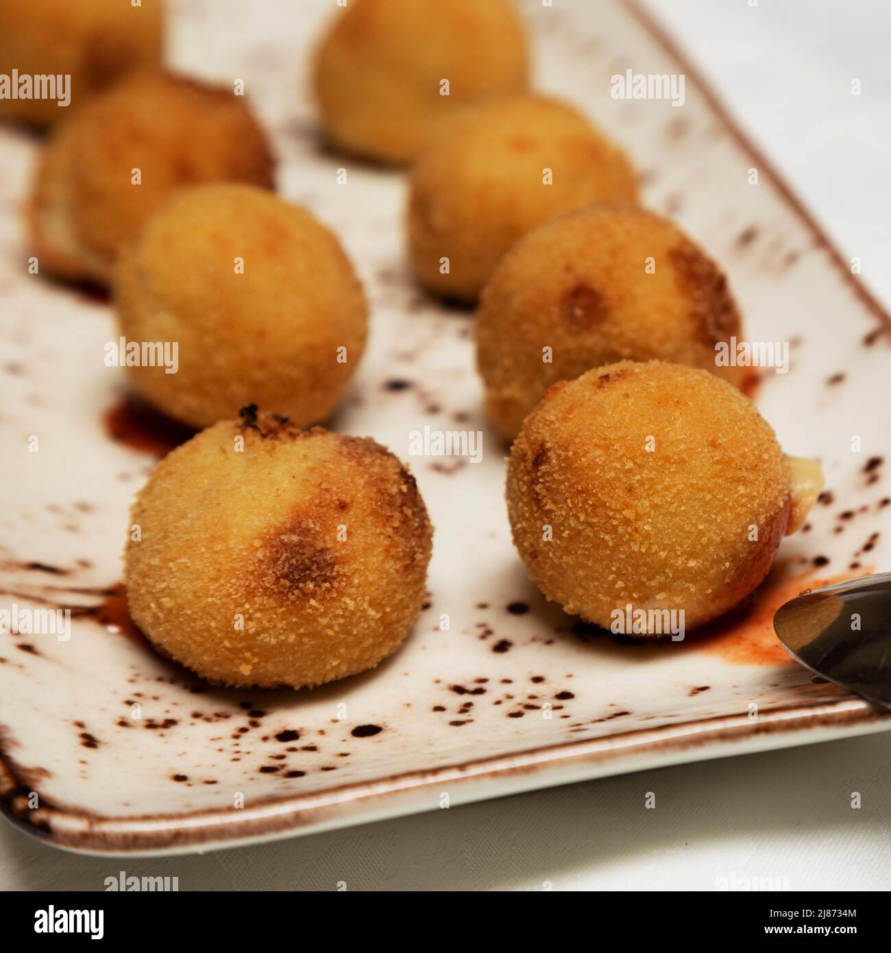 Croquettes (croquetas) filled with cheese served as an appetizer in Tenerife. The deep-fried balls are also a popular tapas. Stock Photo