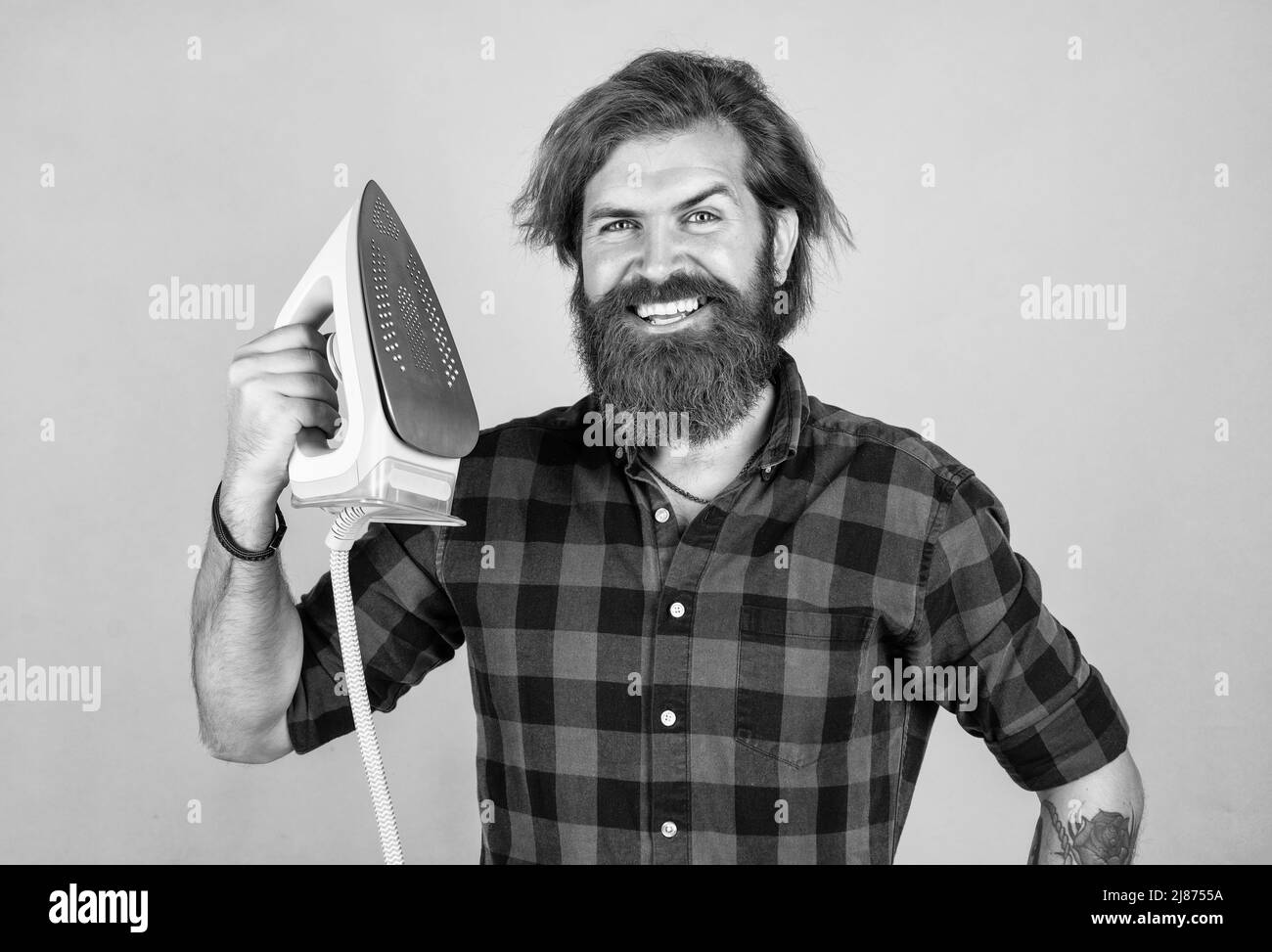 nice quality. home domestic duties. mature brutal hipster use modern technology. household concept. guy ironing diligently. home appliances. happy Stock Photo