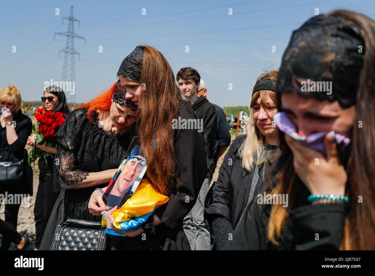 Dnipro, Ukraine. 13th May, 2022. Daughters, wife and relatives of a Ukrainian soldier who was killed in Kharkiv on May 3 during the fight against Russian soldiers on the east, react during the funeral service amid the Russian invasion of Ukraine. Father of Maria was found dead on 8 May, a day before the Russian Victory Day. Thousands of ukranian soldiers and thousands of civilians have been reported killed following the Russian invasion. (Credit Image: © Daniel Ceng Shou-Yi/ZUMA Press Wire) Credit: ZUMA Press, Inc./Alamy Live News Stock Photo