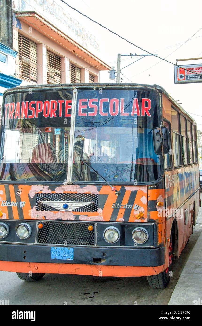 The front of an old Giron bus parked  in the downtown district. The vehicle is used for transporting students (Transporte Escolar) Stock Photo