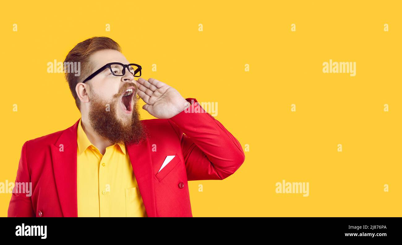 Serious stylish chubby bearded man makes loud advertisement announcing important information. Stock Photo