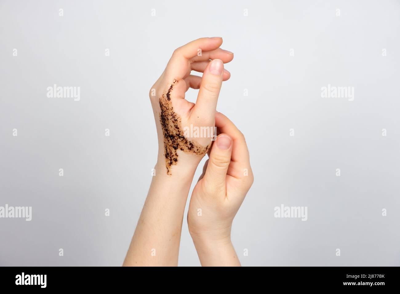 Coffee scrub on women's hands, body and hand skin care, scrubbing and pilling, a place for text Stock Photo